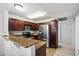 Kitchen features stainless steel appliances, granite countertops, and rich wood cabinetry at 10115 E Mountain View Rd # 2061, Scottsdale, AZ 85258