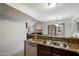 Open kitchen layout with stainless steel dishwasher, granite countertops, and view into living room and dining area at 10115 E Mountain View Rd # 2061, Scottsdale, AZ 85258