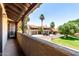 Balcony view of a charming community featuring townhomes, palm trees, and manicured lawn at 10235 N 31St St # 2, Phoenix, AZ 85028