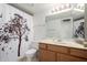 Bathroom with wood cabinets, white sink, and decorative shower curtain at 10235 N 31St St # 2, Phoenix, AZ 85028