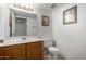 Well-lit bathroom featuring a classic vanity, toilet, and tasteful framed artwork at 10235 N 31St St # 2, Phoenix, AZ 85028