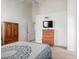 Bright bedroom with tall ceilings and large dresser and an exterior door at 10235 N 31St St # 2, Phoenix, AZ 85028