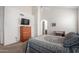Bright bedroom featuring a light ceiling fan and a dresser with a television on top at 10235 N 31St St # 2, Phoenix, AZ 85028
