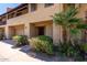 Welcoming condo with an attached garage, quaint front porch, and vibrant green landscaping at 10235 N 31St St # 2, Phoenix, AZ 85028
