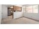 Open kitchen area offering stainless steel appliances, light wood cabinets, and a nearby dining space at 10235 N 31St St # 2, Phoenix, AZ 85028