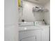 Functional laundry area with side-by-side washer and dryer plus storage shelves at 10235 N 31St St # 2, Phoenix, AZ 85028