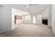 Bright living room featuring vaulted ceilings, fireplace, access to the back patio, and a peek into the kitchen at 10235 N 31St St # 2, Phoenix, AZ 85028