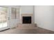 Cozy room featuring a corner fireplace, neutral walls, and outdoor access at 10235 N 31St St # 2, Phoenix, AZ 85028