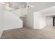 Spacious living room with vaulted ceilings and bright white walls, leading to an adjacent kitchen area at 10235 N 31St St # 2, Phoenix, AZ 85028