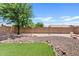 Low maintenance backyard with artificial turf, gravel, and shade tree at 10617 W Ross Ave, Peoria, AZ 85382