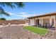 Landscaped backyard with a covered patio, artificial turf, and seating area at 10617 W Ross Ave, Peoria, AZ 85382