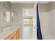 Bathroom with wood cabinets, white countertops, and shower with blue curtain at 10617 W Ross Ave, Peoria, AZ 85382