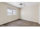 Bedroom featuring neutral walls, carpet flooring, a ceiling fan, and a window at 10617 W Ross Ave, Peoria, AZ 85382