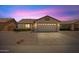 Charming single-story home featuring a two-car garage and desert landscaping set against a pink sunset sky at 10617 W Ross Ave, Peoria, AZ 85382