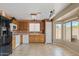 Eat-in kitchen featuring tile flooring, light wood cabinets, and modern white and black appliances at 10617 W Ross Ave, Peoria, AZ 85382