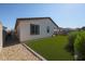 A well-maintained backyard features artificial turf and gravel landscaping, perfect for outdoor relaxation and low maintenance at 10964 W Garfield St, Avondale, AZ 85323