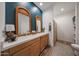 Stylish bathroom featuring double sinks, quartz countertop, and wood-look flooring at 10964 W Garfield St, Avondale, AZ 85323