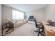 Cozy bedroom with a comfortable sofa, desk, and a large window providing natural light at 10964 W Garfield St, Avondale, AZ 85323