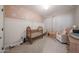 Charming Bedroom with a crib, chair, and decorative daisy-themed wall at 10964 W Garfield St, Avondale, AZ 85323