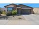 Charming single-story home featuring a two-car garage and low-maintenance desert landscaping at 10964 W Garfield St, Avondale, AZ 85323