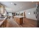 Open concept kitchen with large center island, stainless steel appliances, and access to dining/living area at 10964 W Garfield St, Avondale, AZ 85323