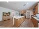 Spacious kitchen featuring a large island, stainless appliances, ample counter space, and wood-look flooring at 10964 W Garfield St, Avondale, AZ 85323