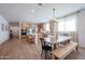 Open-concept kitchen and dining area, featuring stylish lighting and wood-look flooring at 10964 W Garfield St, Avondale, AZ 85323
