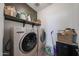 Functional laundry area with appliances, shelving, and ample storage solutions at 10964 W Garfield St, Avondale, AZ 85323