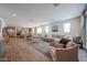 Open-concept living room with hardwood floors, a comfortable seating area, and a view into the kitchen at 10964 W Garfield St, Avondale, AZ 85323