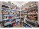 Walk-in pantry with ample shelving providing convenient storage for all of your groceries and essentials at 10964 W Garfield St, Avondale, AZ 85323