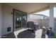 Covered patio with a grill is the perfect outdoor dining spot, with sliding glass doors for seamless indoor-outdoor flow at 10964 W Garfield St, Avondale, AZ 85323