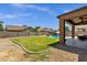 A large well manicured backyard with a covered patio and pool at 1130 E Harvest Rd, San Tan Valley, AZ 85140