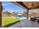 Beautiful backyard with a pool, patio, and well-maintained landscaping at 1130 E Harvest Rd, San Tan Valley, AZ 85140