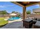 Outdoor oasis featuring a pool with a waterfall, and a covered patio at 1130 E Harvest Rd, San Tan Valley, AZ 85140