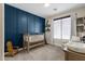 Cozy Bedroom with a crib and blue accent wall at 1130 E Harvest Rd, San Tan Valley, AZ 85140
