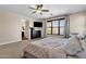 Inviting bedroom featuring a king bed, ceiling fan, and plenty of natural light from the large window at 1130 E Harvest Rd, San Tan Valley, AZ 85140