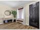 Inviting entryway with wood-look floors, bench, and decorative mirror, creating a welcoming space at 1130 E Harvest Rd, San Tan Valley, AZ 85140