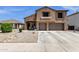 Well-maintained two-story home features stucco and brick accents, three-car garage, and inviting curb appeal at 1130 E Harvest Rd, San Tan Valley, AZ 85140