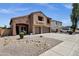 Spacious two-story home boasts stucco and brick exterior, three-car garage, and low maintenance landscaping at 1130 E Harvest Rd, San Tan Valley, AZ 85140