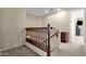 Upstairs hallway with wood railing, and cozy carpeting leading to the bedrooms and bathrooms at 1130 E Harvest Rd, San Tan Valley, AZ 85140