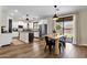 Bright eat-in kitchen features stainless steel appliances, island, and sliding glass doors to backyard at 1130 E Harvest Rd, San Tan Valley, AZ 85140