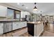 Kitchen featuring stainless steel appliances, center island, white cabinets, and backyard view at 1130 E Harvest Rd, San Tan Valley, AZ 85140