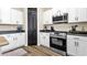 Kitchen features stainless steel appliances, white cabinets, and modern appliances at 1130 E Harvest Rd, San Tan Valley, AZ 85140