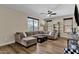Inviting living room with plush sectional couch and natural light from the windows at 1130 E Harvest Rd, San Tan Valley, AZ 85140