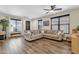 Cozy living room featuring wood-look floors and an abundance of natural light, creating a welcoming atmosphere at 1130 E Harvest Rd, San Tan Valley, AZ 85140