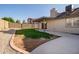 Nice backyard featuring a grass patch, stone, cement patio, and covered area attached to the house at 11615 N 77Th Dr, Peoria, AZ 85345
