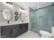 Updated bathroom with dual sinks and glass-enclosed shower with blue tiling at 11615 N 77Th Dr, Peoria, AZ 85345