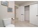 Bathroom featuring a toilet, artwork, and a closet at 11615 N 77Th Dr, Peoria, AZ 85345