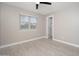 Cozy bedroom with a ceiling fan, window and tile flooring at 11615 N 77Th Dr, Peoria, AZ 85345
