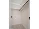 A well-organized closet features a wooden rod for hanging clothes and a neutral-toned tile floor at 11615 N 77Th Dr, Peoria, AZ 85345